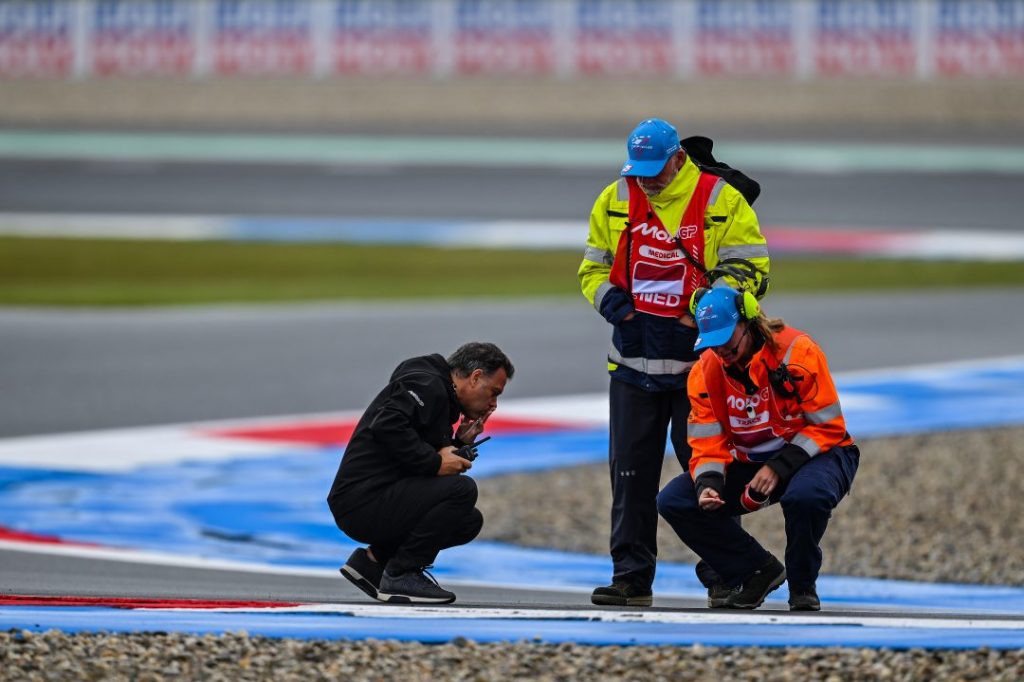 FIM Safety Officer and MotoGP track marshals inspecting a racing circuit during an official safety check.